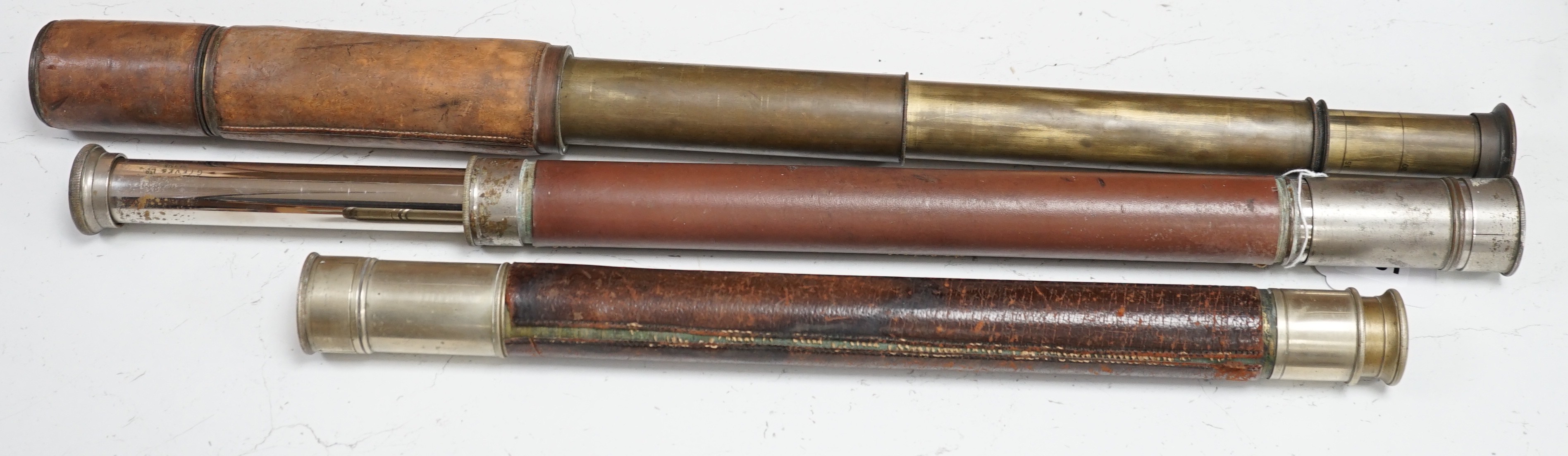 Three leather bound telescopes